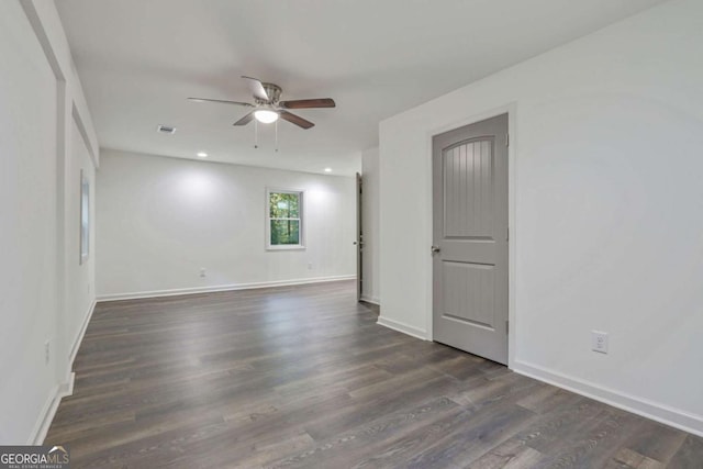 unfurnished room with dark hardwood / wood-style floors and ceiling fan