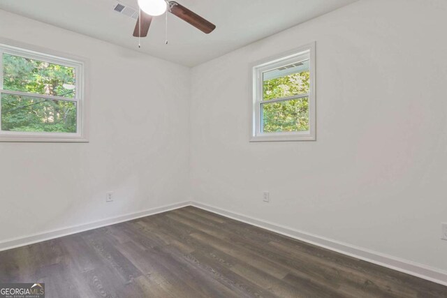 unfurnished room with dark hardwood / wood-style flooring, ceiling fan, and a healthy amount of sunlight