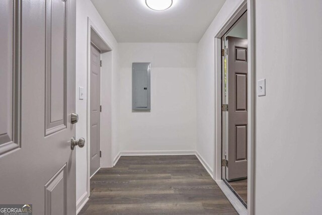 corridor with electric panel and dark wood-type flooring