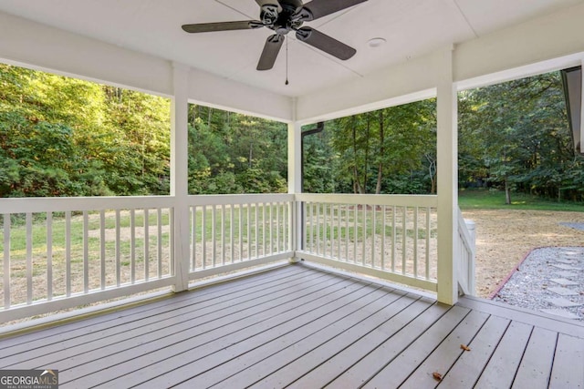 wooden deck featuring ceiling fan