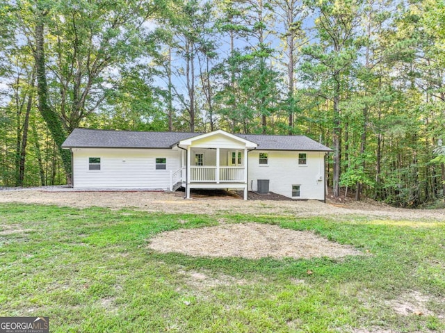 back of property with a porch, a yard, and central AC unit