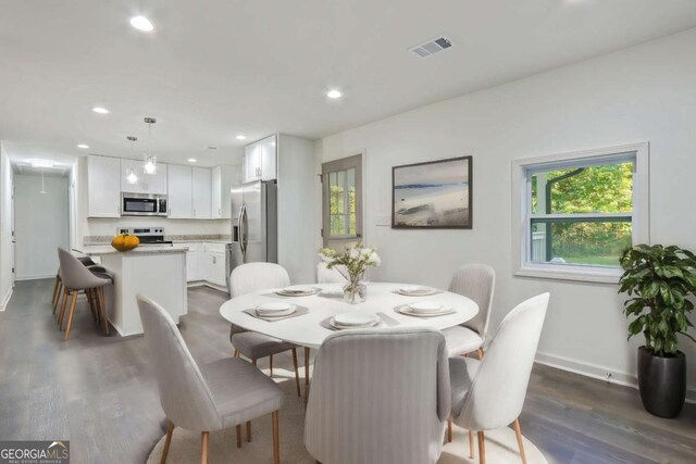 dining area featuring dark hardwood / wood-style flooring