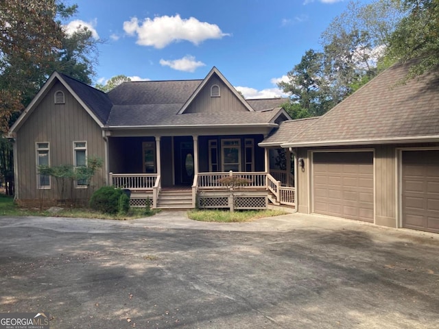 view of front of house featuring covered porch and a garage