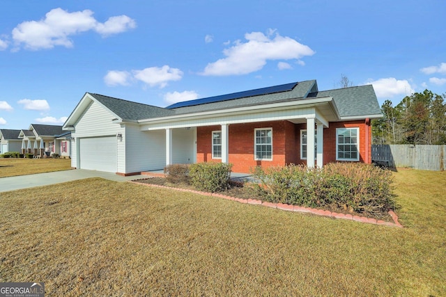 view of front of property with solar panels, a garage, covered porch, and a front lawn