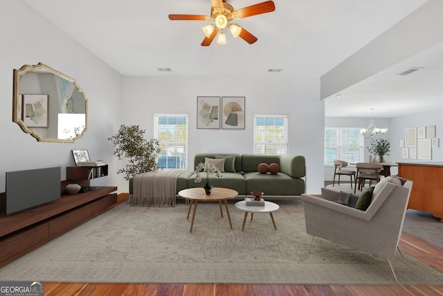 living room featuring hardwood / wood-style floors and ceiling fan with notable chandelier