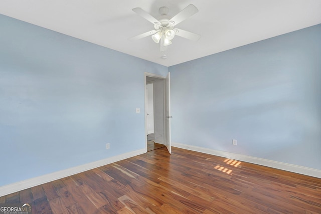 unfurnished room with ceiling fan and dark hardwood / wood-style floors