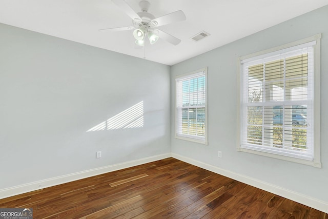 spare room with dark hardwood / wood-style floors and ceiling fan