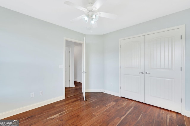 unfurnished bedroom with a closet, ceiling fan, and dark hardwood / wood-style floors