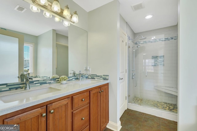 bathroom with vanity and a shower with shower door