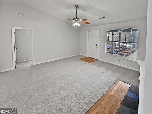 unfurnished living room featuring carpet and ceiling fan