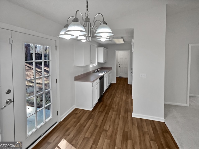 kitchen featuring stainless steel dishwasher, dark hardwood / wood-style floors, a notable chandelier, pendant lighting, and white cabinets