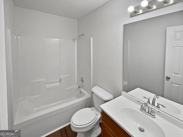 full bathroom featuring vanity, shower / washtub combination, hardwood / wood-style flooring, toilet, and a textured ceiling