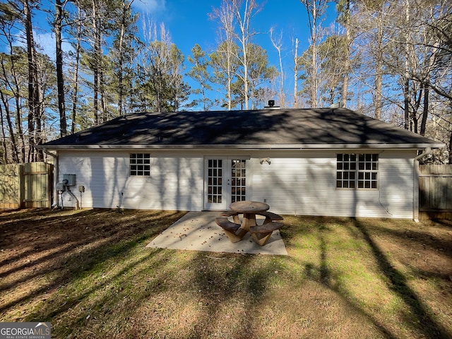 back of house with a lawn, a patio, and french doors