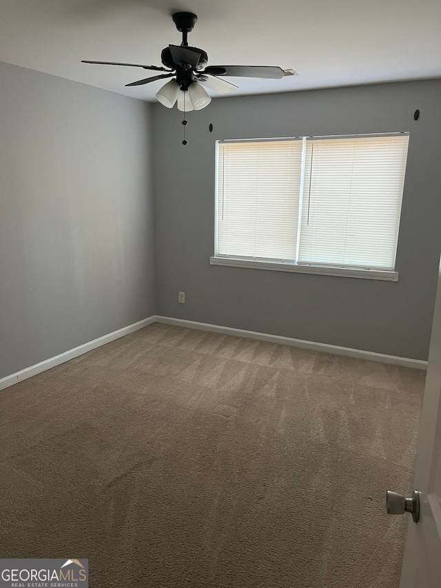 carpeted spare room with ceiling fan and a healthy amount of sunlight