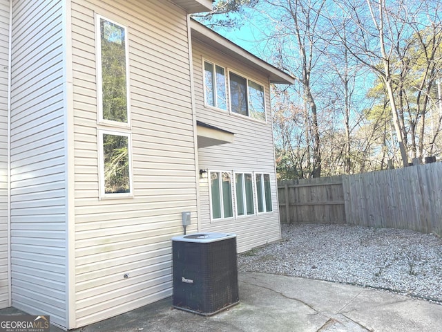 view of side of property with a patio area and central AC unit