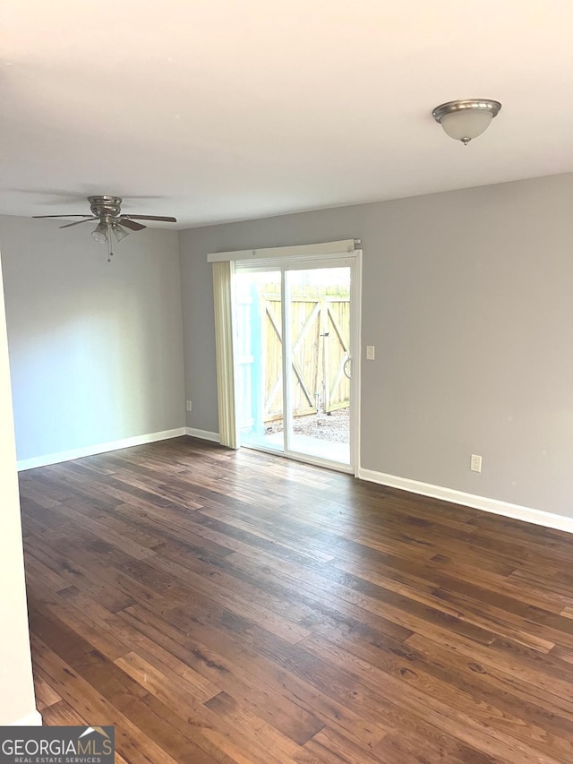 spare room with ceiling fan and dark hardwood / wood-style floors