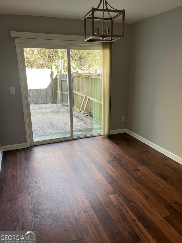 unfurnished dining area featuring plenty of natural light and dark wood-type flooring