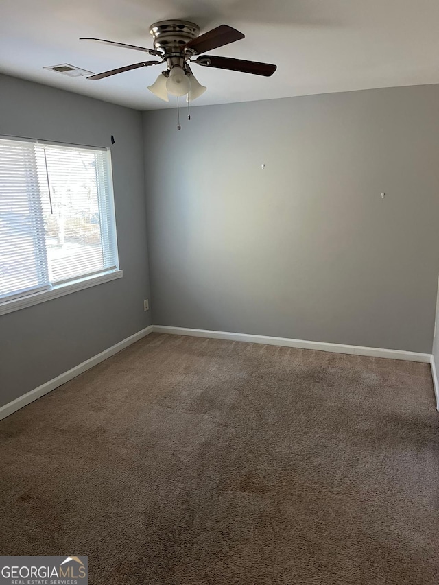 unfurnished room featuring carpet and ceiling fan