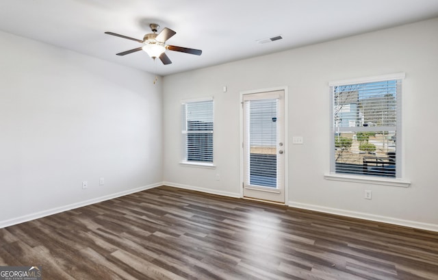 spare room with dark hardwood / wood-style flooring and ceiling fan