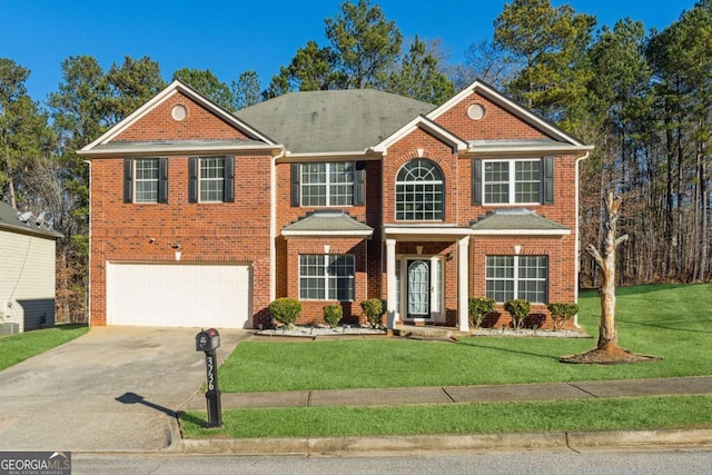 view of front of home featuring a front yard and a garage