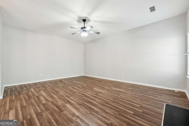 spare room featuring ceiling fan and dark wood-type flooring