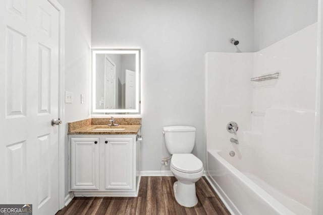 full bathroom with bathtub / shower combination, hardwood / wood-style floors, vanity, and toilet