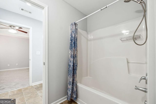 bathroom featuring ceiling fan and shower / bathtub combination with curtain