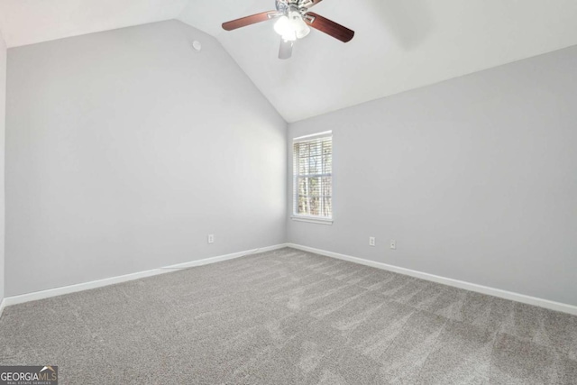 spare room featuring ceiling fan, lofted ceiling, and carpet floors