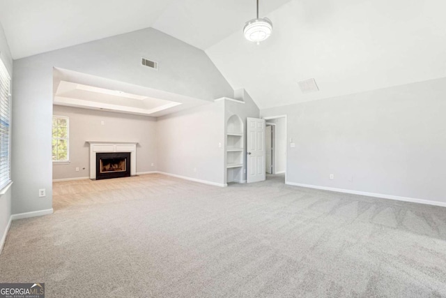 unfurnished living room with light colored carpet and vaulted ceiling