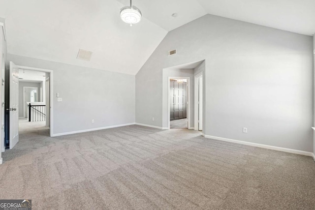 interior space with light colored carpet and vaulted ceiling