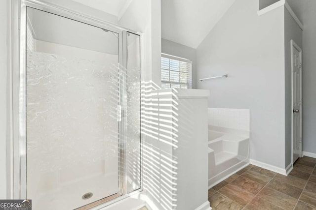 bathroom featuring independent shower and bath and lofted ceiling