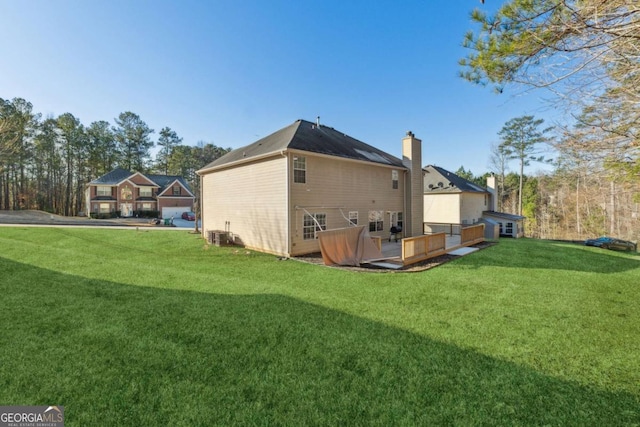 rear view of property with a lawn