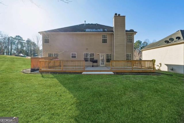 back of house with a yard and a wooden deck