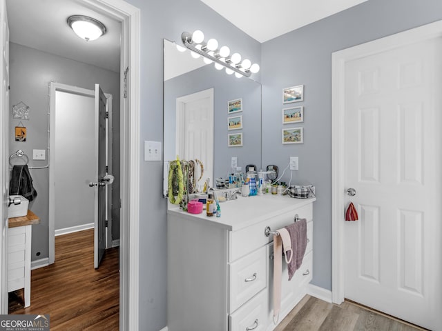 bathroom with hardwood / wood-style floors and vanity