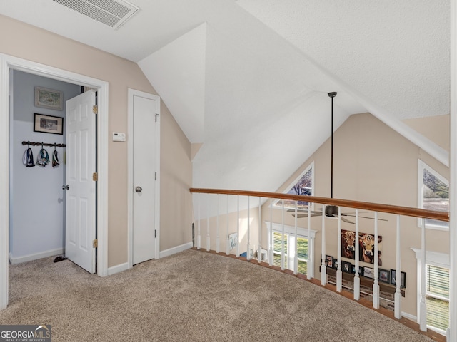 interior space with carpet and vaulted ceiling