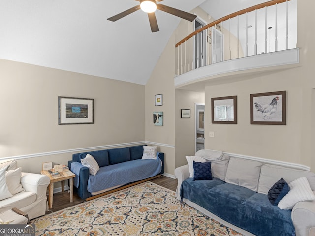 living room featuring ceiling fan, high vaulted ceiling, and hardwood / wood-style flooring