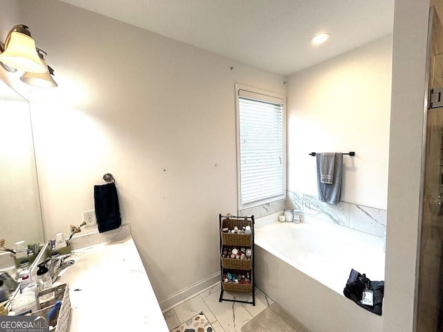 bathroom featuring a washtub and sink