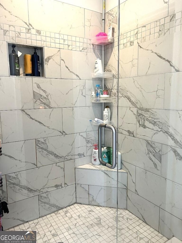 bathroom with a shower with shower door