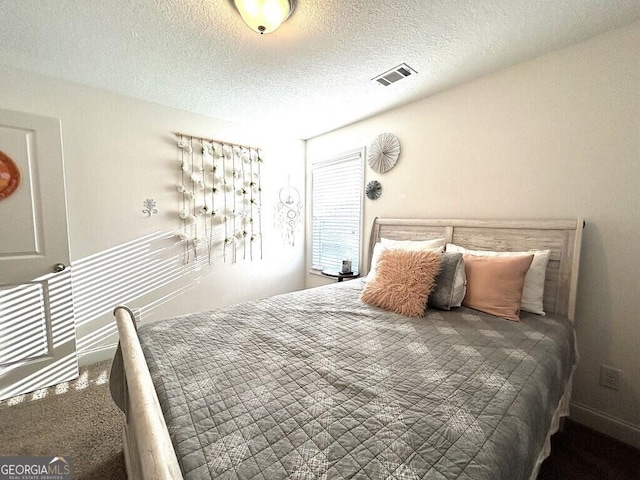 carpeted bedroom featuring a textured ceiling