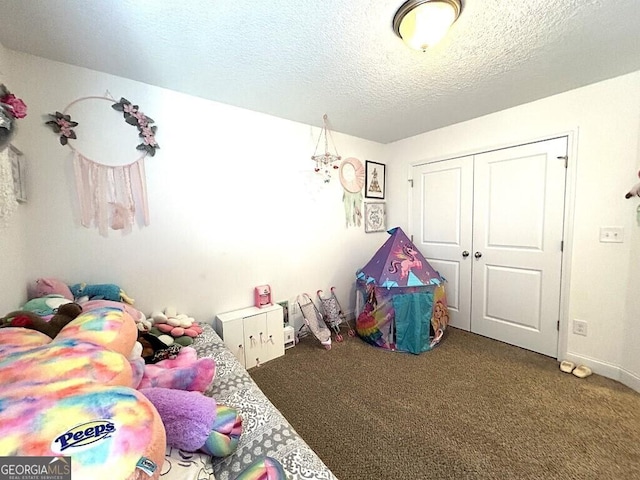 game room featuring carpet flooring and a textured ceiling