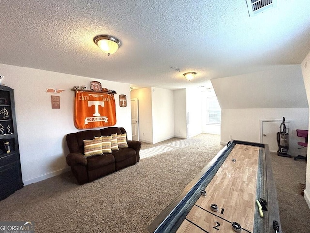 recreation room with carpet, lofted ceiling, and a textured ceiling