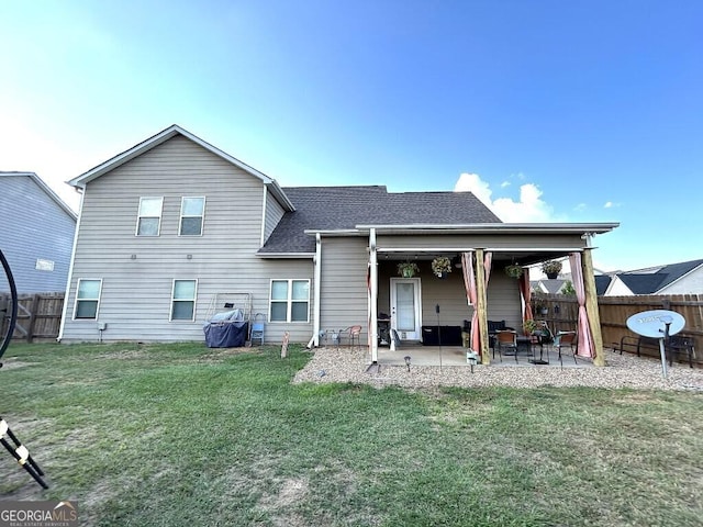 rear view of property with a lawn and a patio area