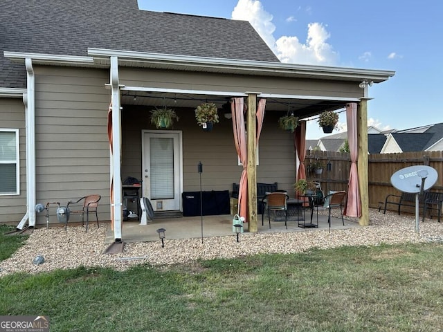 back of property featuring a patio area and a yard