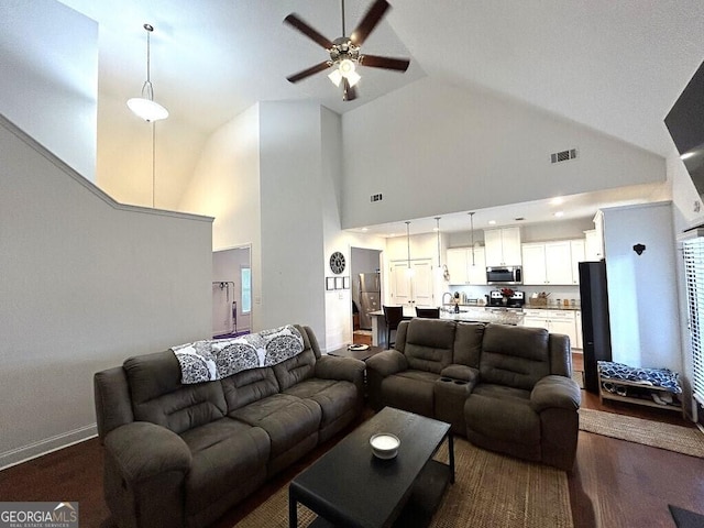 living room with ceiling fan, sink, and high vaulted ceiling