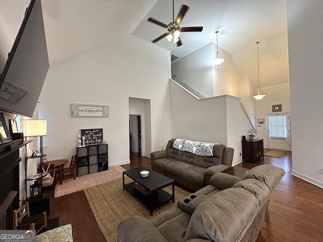 living room featuring ceiling fan, dark hardwood / wood-style flooring, and high vaulted ceiling