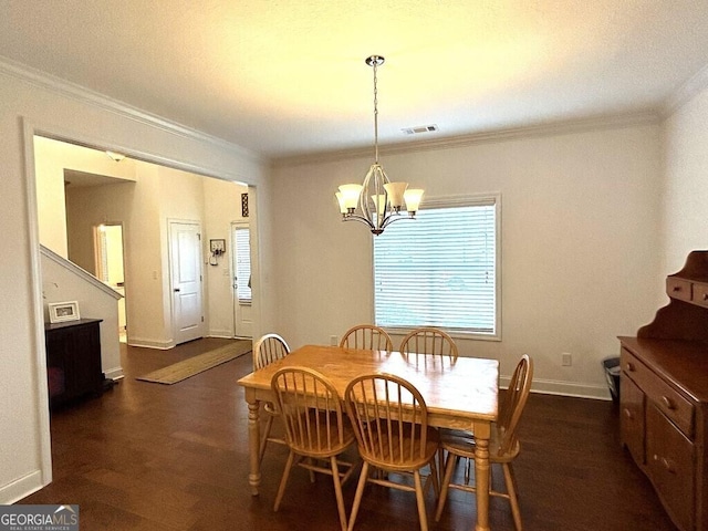 dining space featuring a notable chandelier, ornamental molding, and dark wood-type flooring