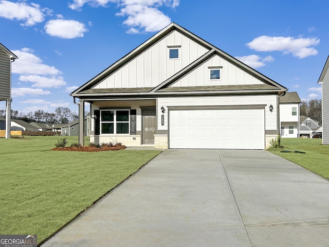 view of front facade featuring board and batten siding, concrete driveway, a front yard, a garage, and brick siding