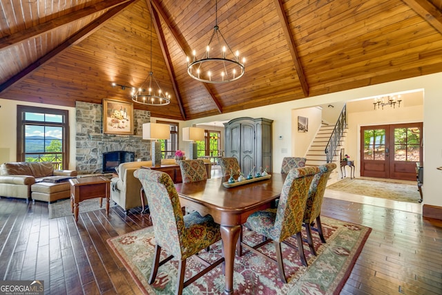 dining room featuring french doors, wooden ceiling, dark hardwood / wood-style flooring, high vaulted ceiling, and a fireplace