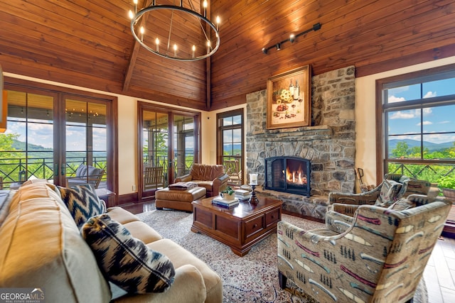 living room with a fireplace, high vaulted ceiling, and plenty of natural light