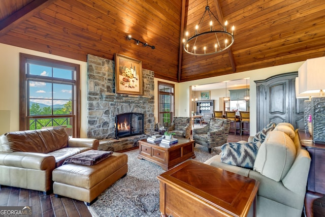 living room with wood ceiling, high vaulted ceiling, beamed ceiling, a fireplace, and a chandelier